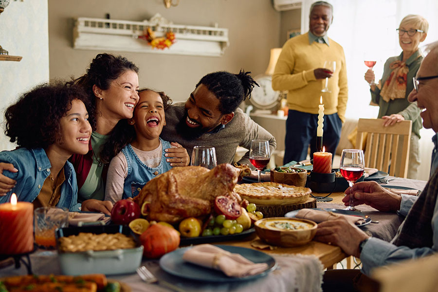 Cheerful multiracial family having fun while gathering for Thanksgiving at home