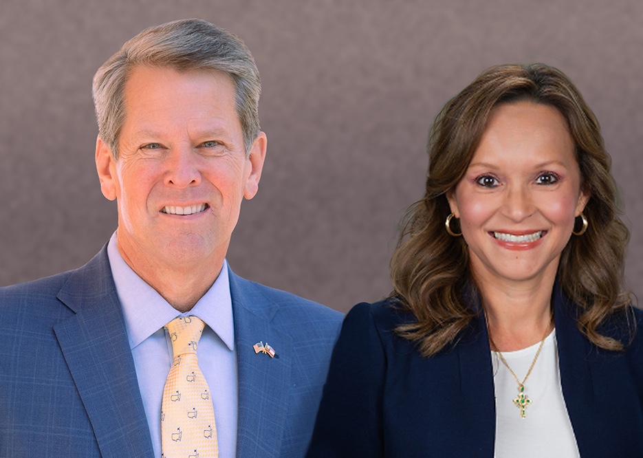 A man and a woman in professional attire smiling, posing against a neutral background.