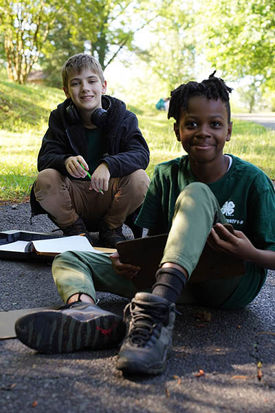 4-H'ers smile at the camera while participating in wildlife judging
