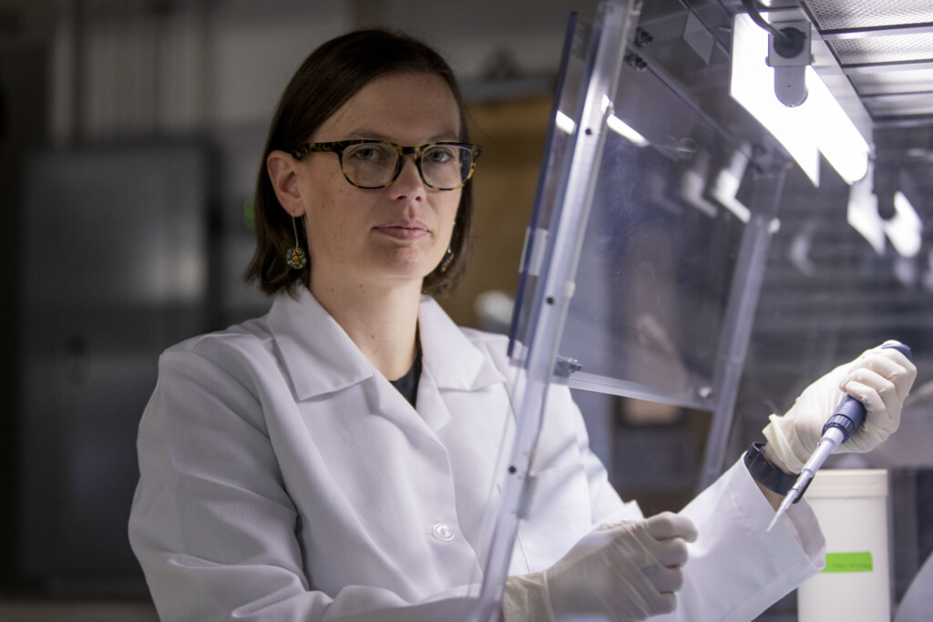 Gaelen Burke wears PPE to conduct work in her laboratory