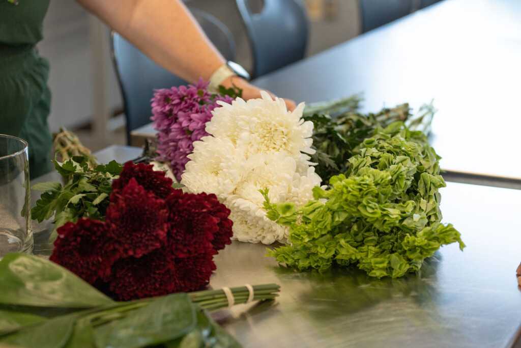 Flowers being arranged on a stainless steel table
