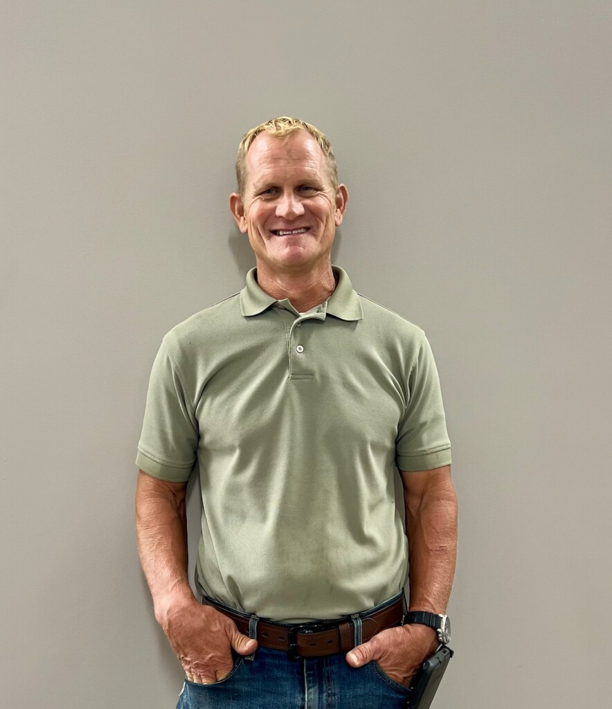 Jeff Cook smiles with his hands in his pockets