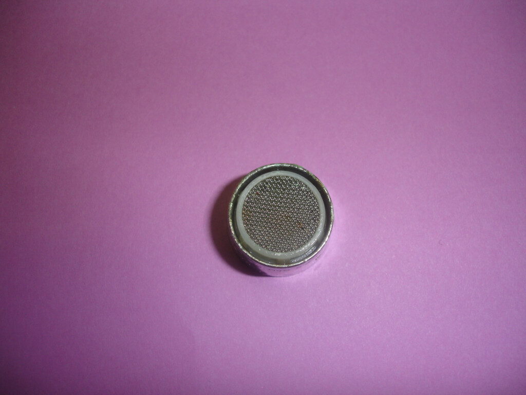 Close-up photo of the faucet aerator after being removed