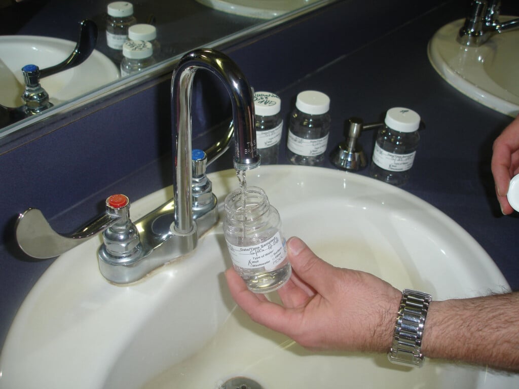 the water sample bottle is filled with water from a faucet