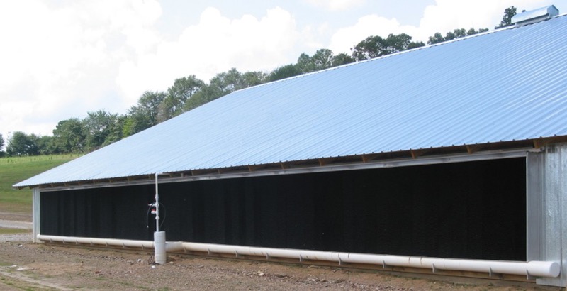 A recirculating evaporative cooling system on the inlet end of a tunnel-ventilated broiler house.