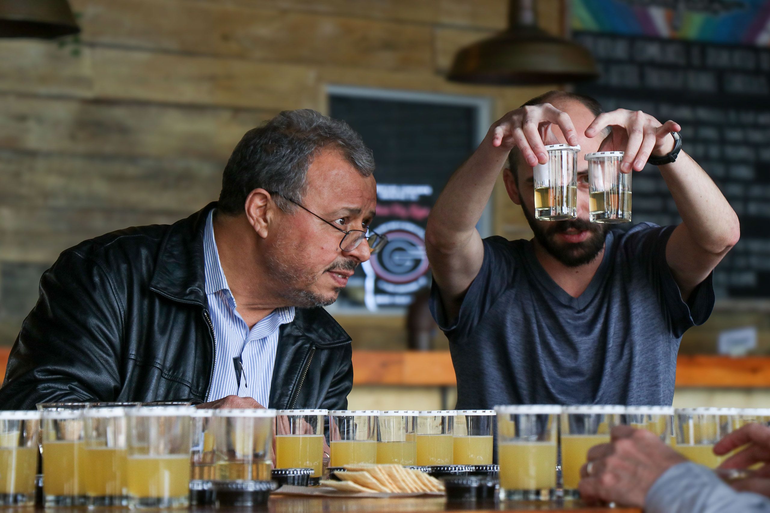 Mergoum looks at beer samples at Creature Comforts