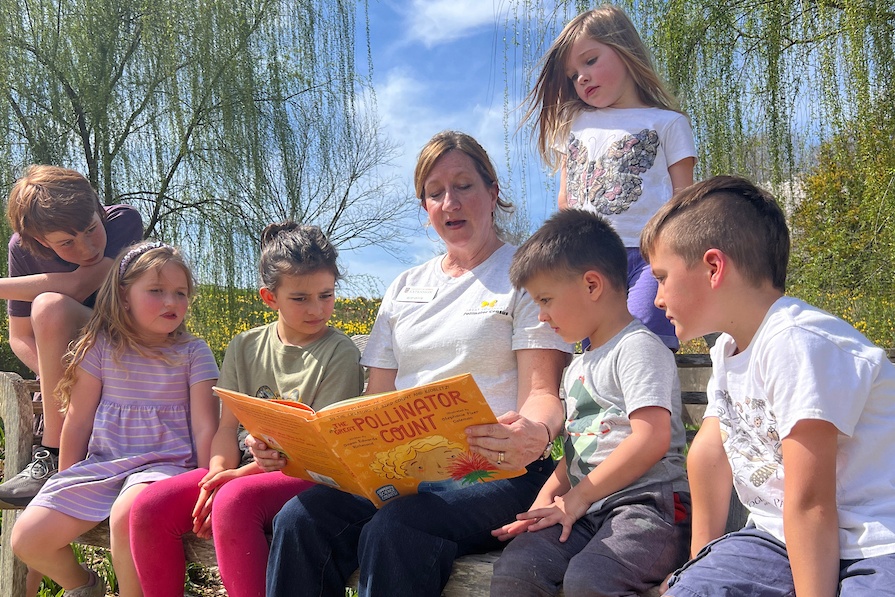 Becky Griffin reads to six children