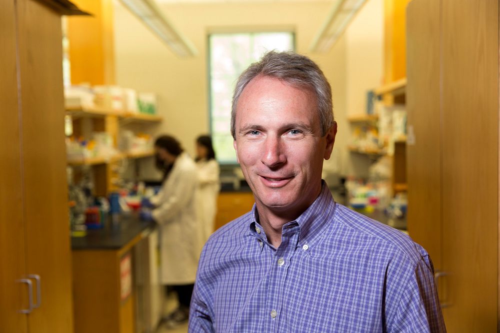 Scott Jackson smiles in the entrance of his lab