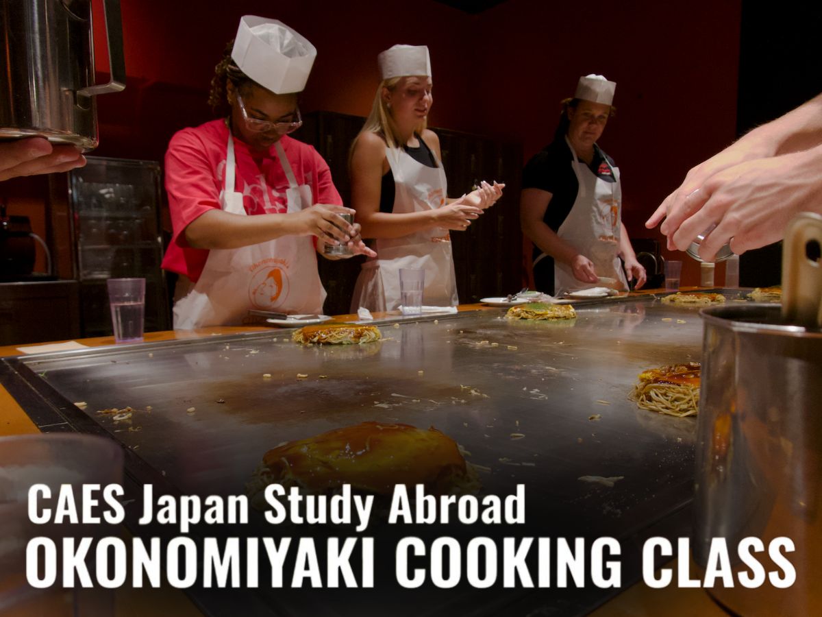 Students participating in a cooking class with the words "CAES Japan Study Abroad: Okonomiyaki cooking class" overlayed in white.