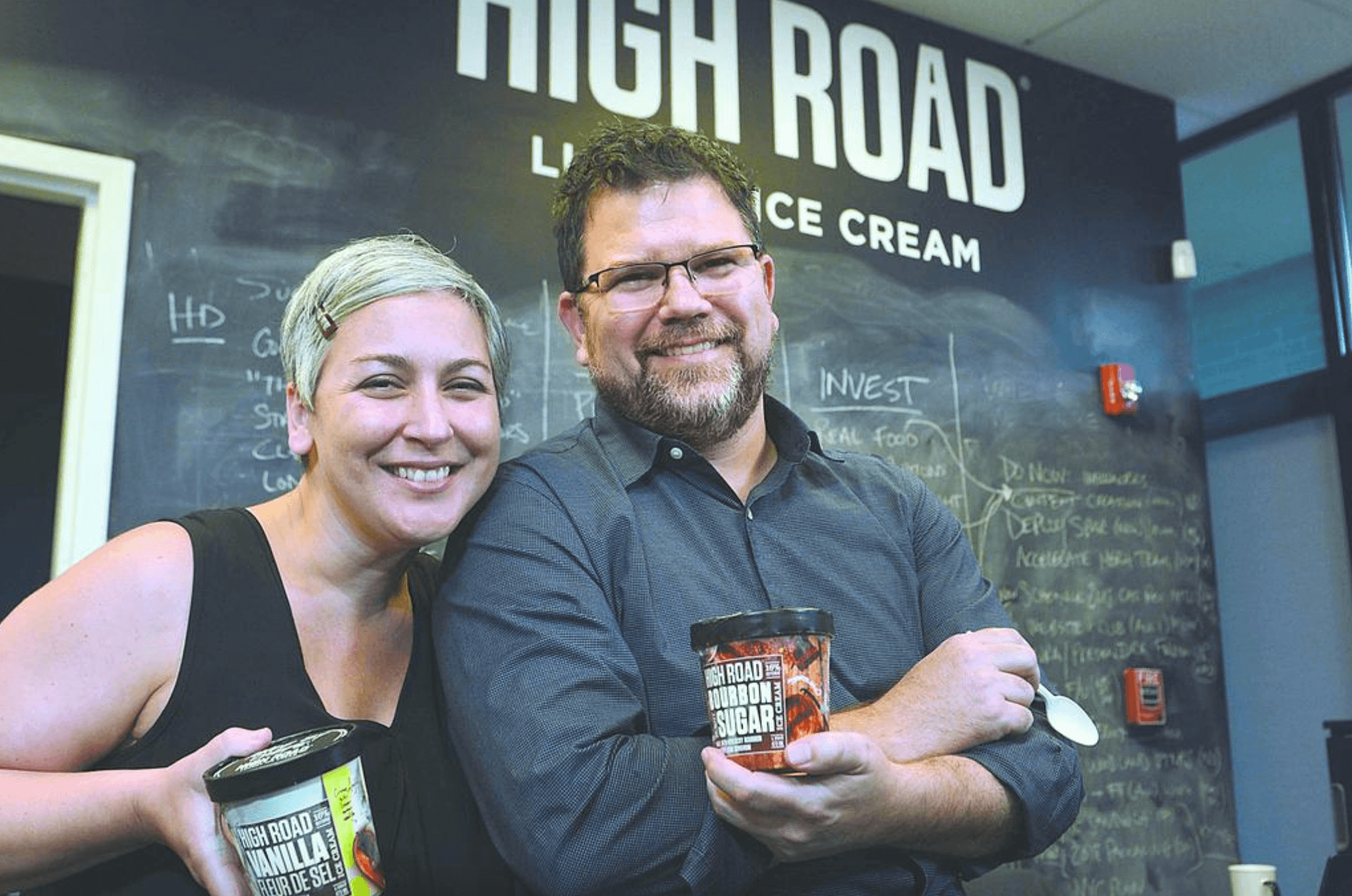 Nicki and Keith Schroeder hold cartons of ice cream at High Road Craft