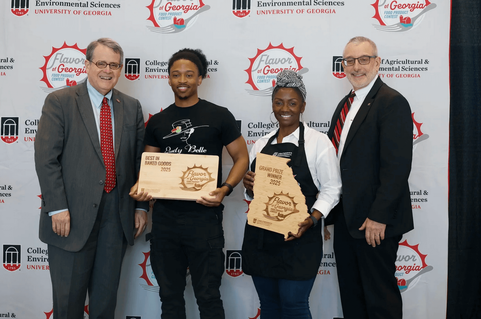 UGA President Jere Morehead (left) and CAES Dean Nick Place (right) congratulate Lady Belle (center) for winning Best in Baked Goods and the contest's grand prize.