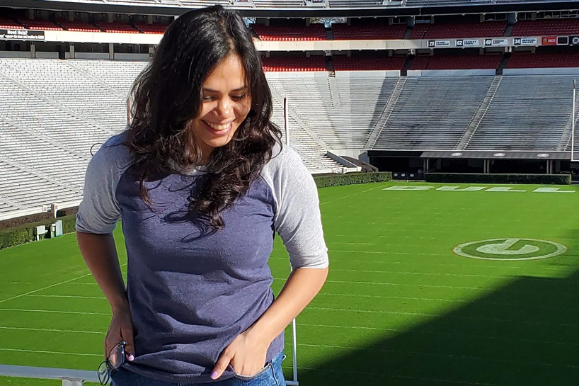 Samikshya Rijal smiles in the stands at Sanford Stadium