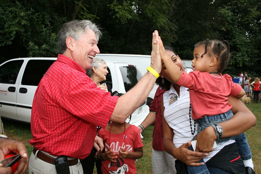 Broder gives a young child a high five