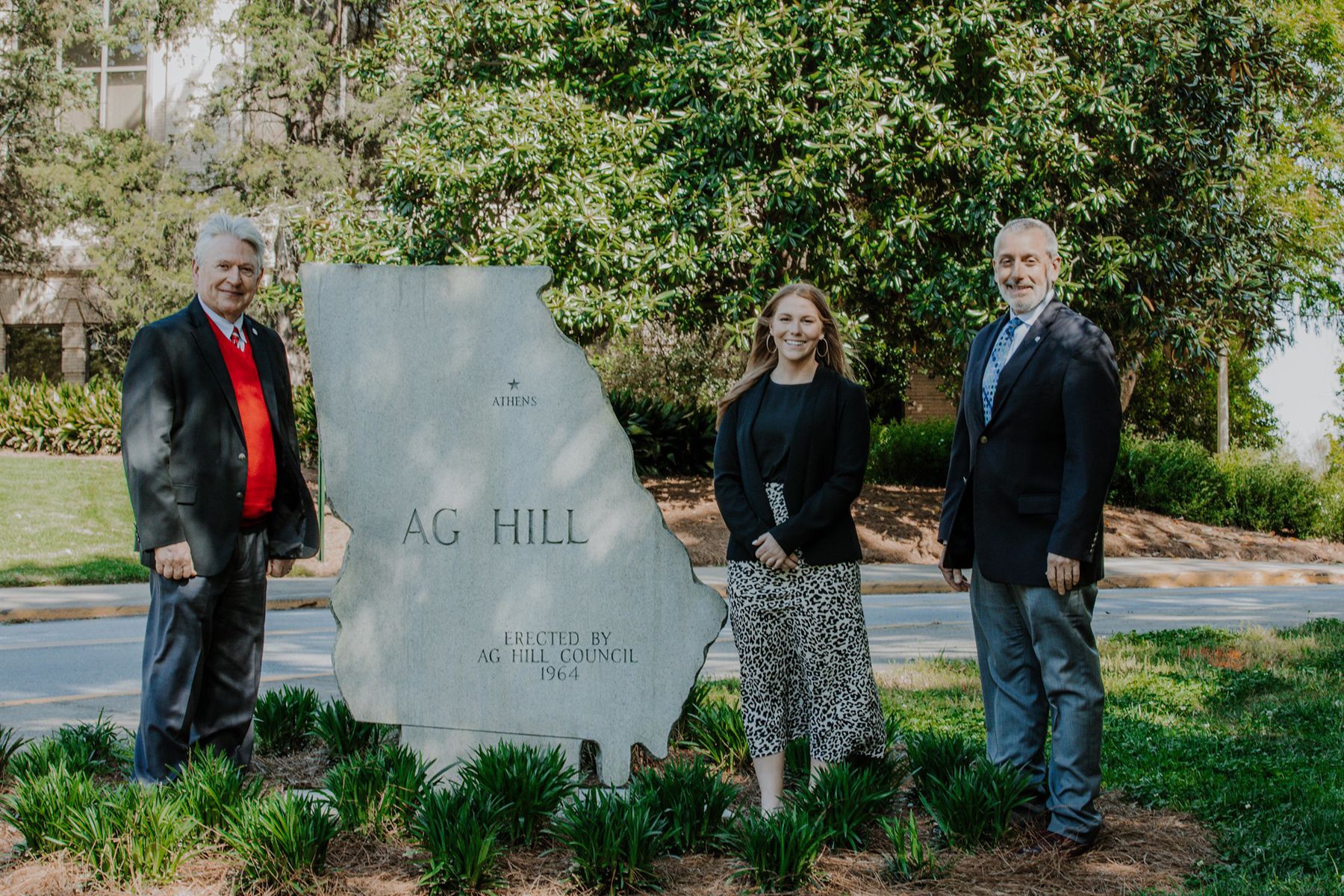Joe Broder next to the Georgia-shaped Ag Hill sign