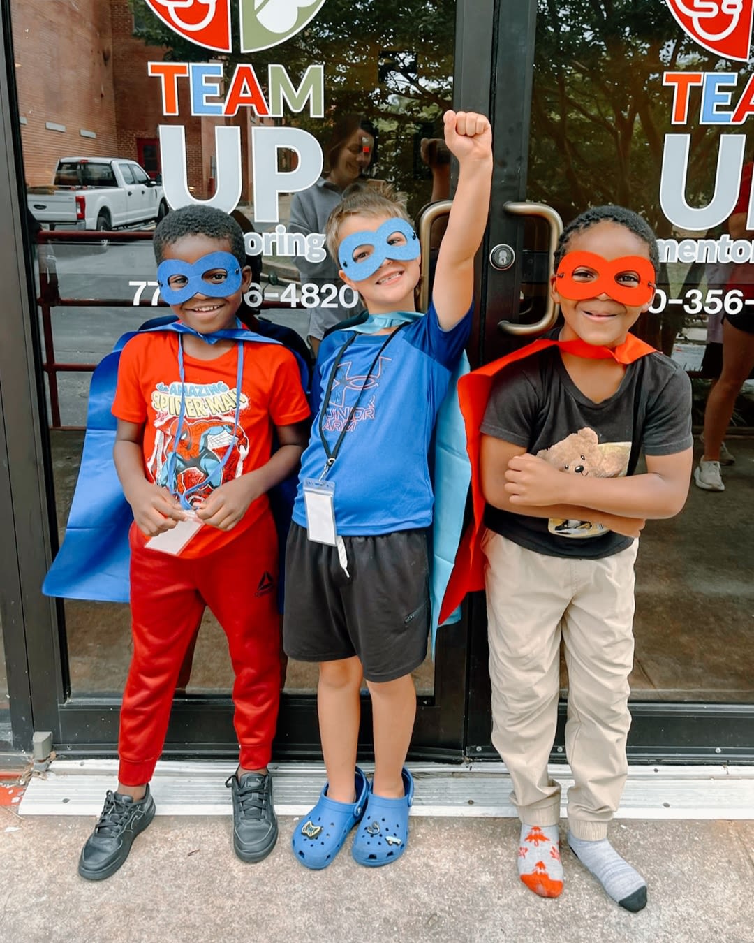 Young boys in superhero costumes