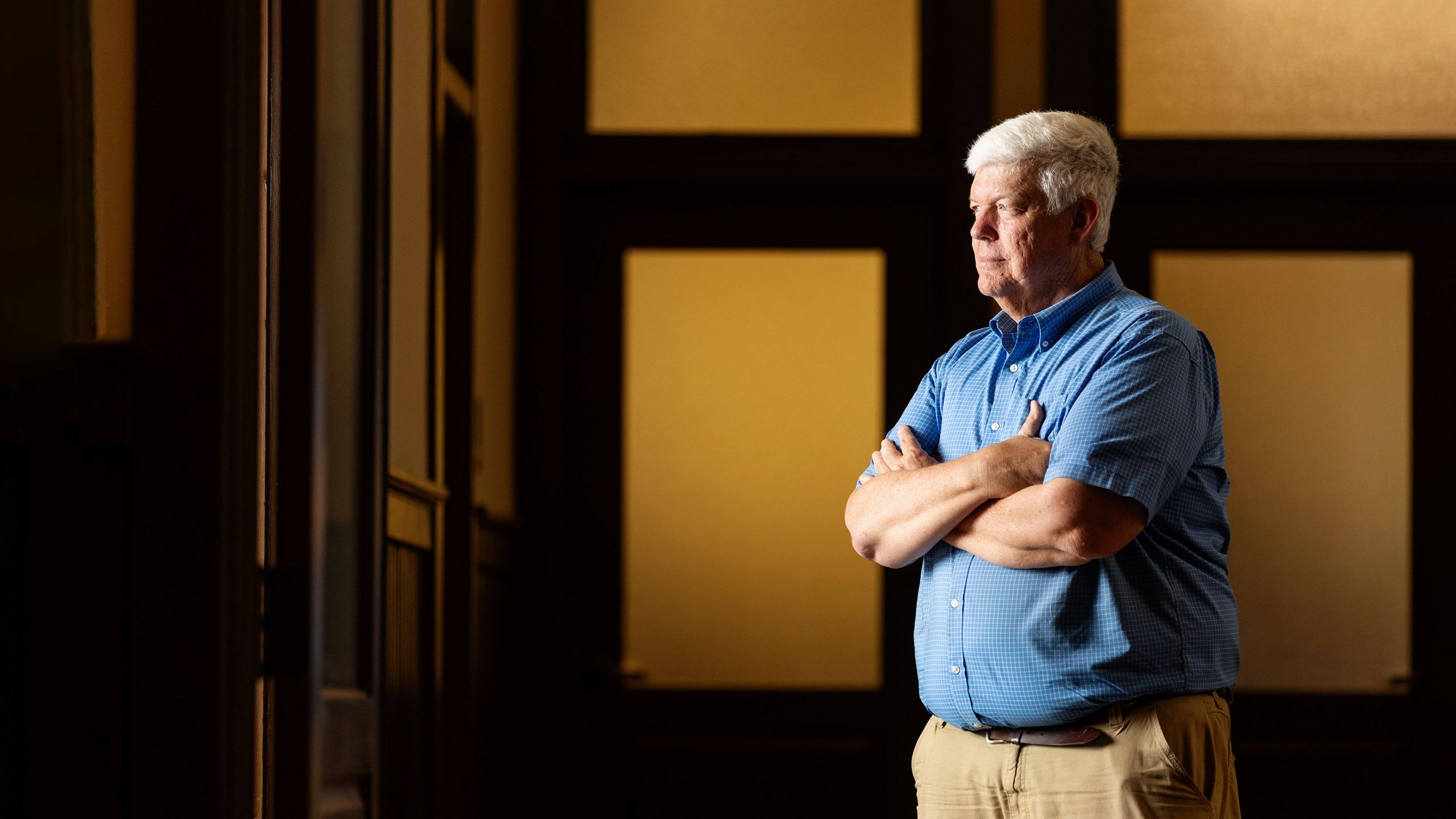 Bob Kemerait wearing a button down blue shirt staring off into the distance