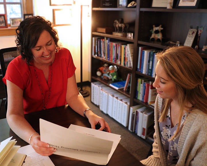 Lamm and Katie Sanders look over their files in Lamm's office
