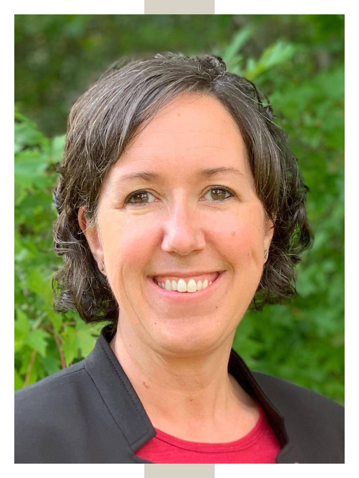 Alexa Lamm smiles against a background of greenery