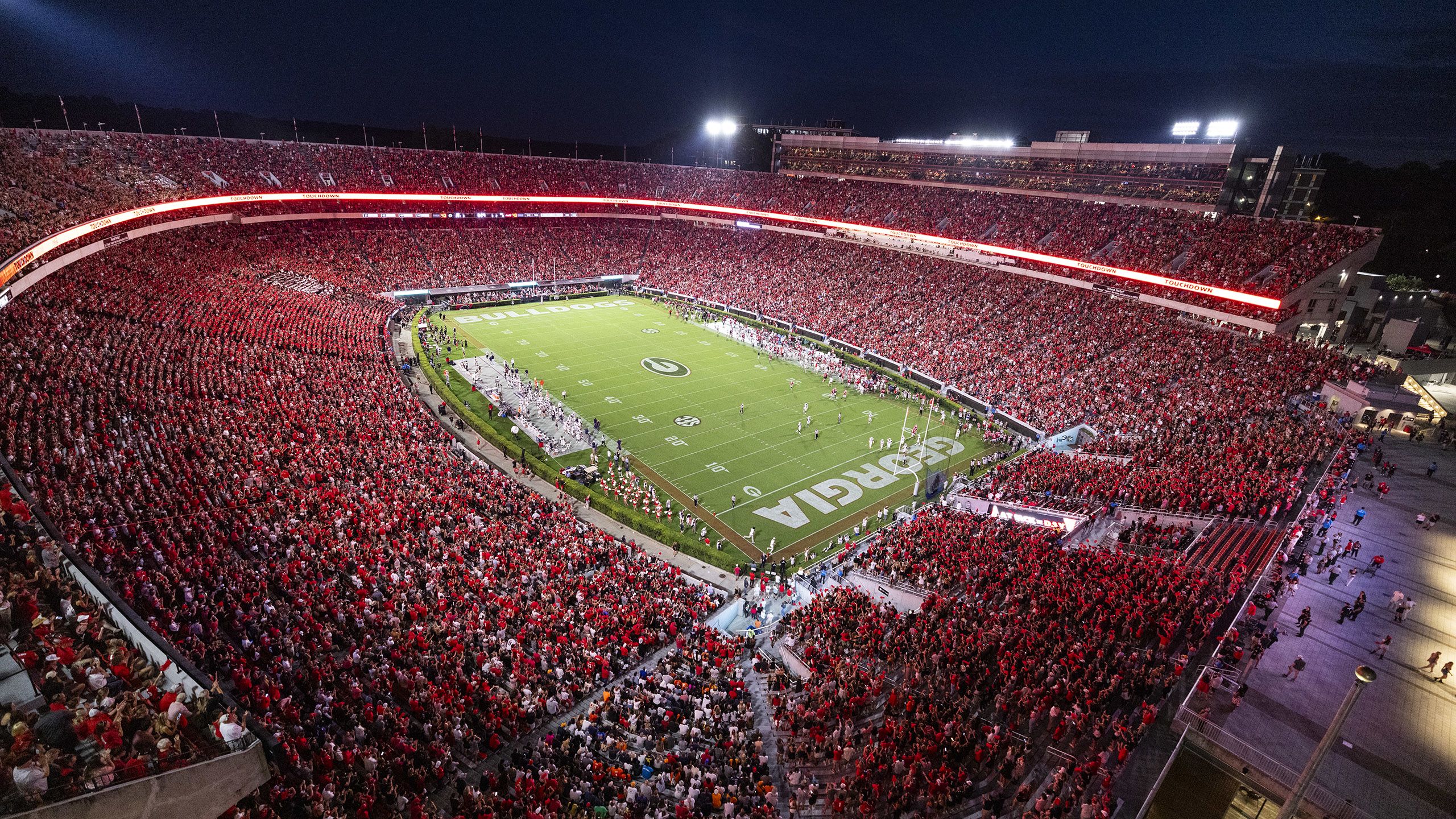 Sanford Stadium filled with people at night