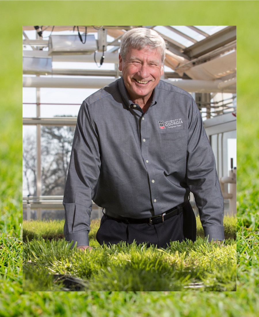 A headshot of Paul Raymer standing in a greenhouse