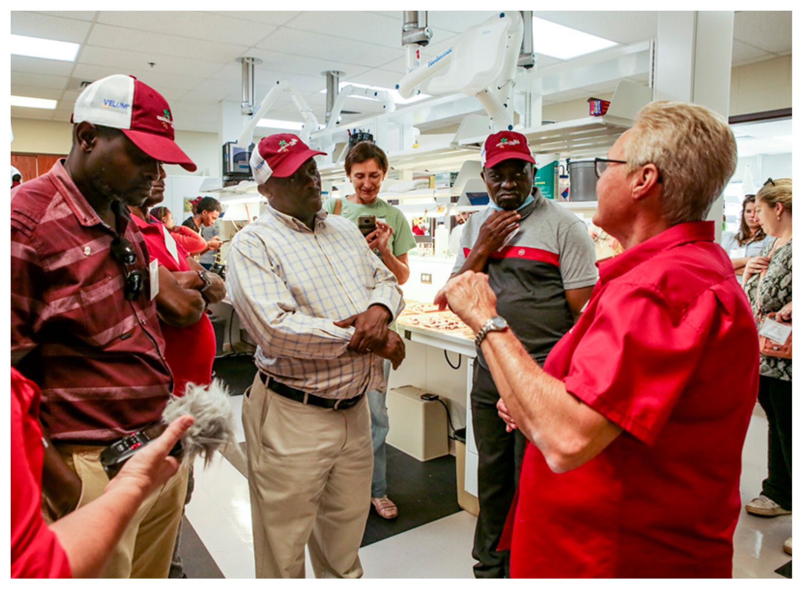 Several participants in the Georgia Peanut Tour stand in front of Dee Dee Smith, a seed analyst at the Georgia Department of Agriculture’s Tifton Agricultural Seed Lab, as she explains the process of testing peanut samples for germination and check for aflatoxin.