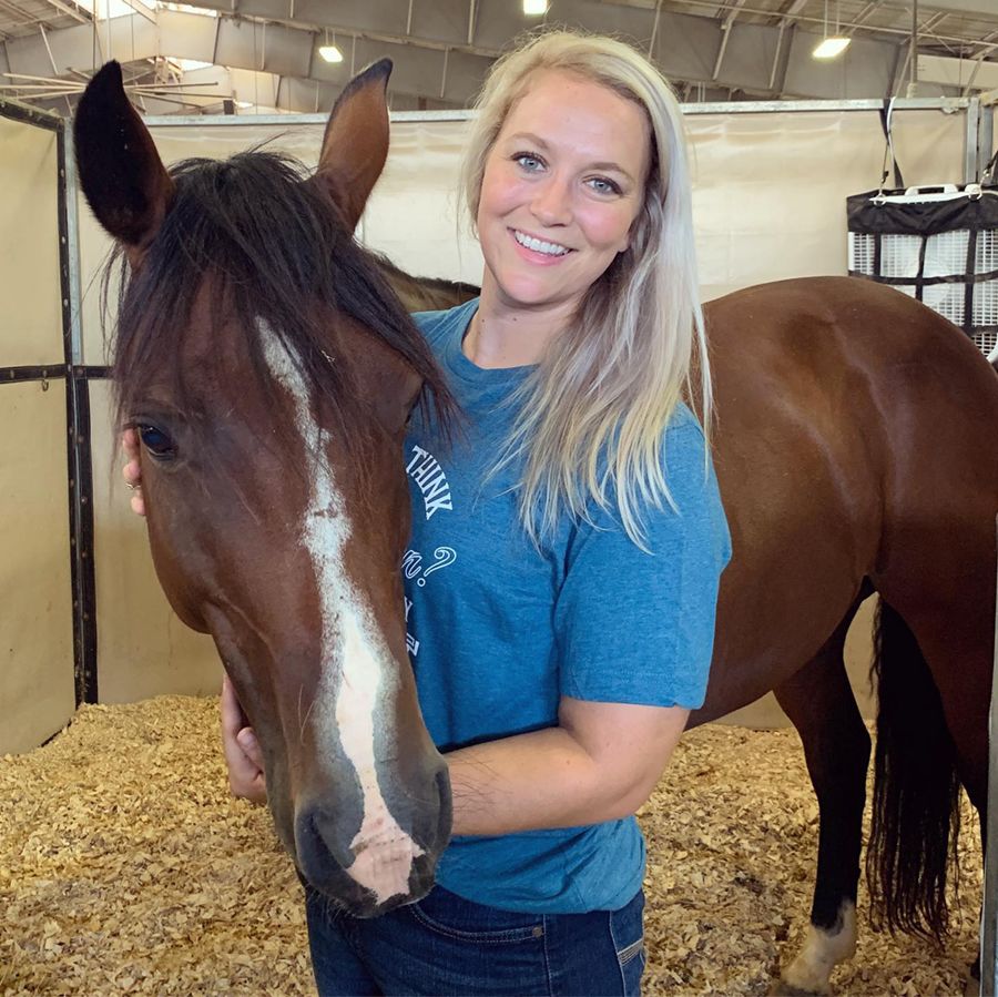Ashley Best stands with a horse