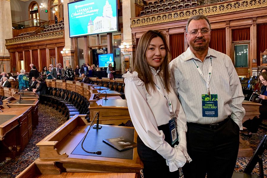 Uugii Ganbaatar and Mohamed Mergoum stand in a large meeting room