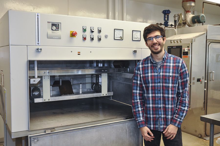 Ozan Altin stands in a lab