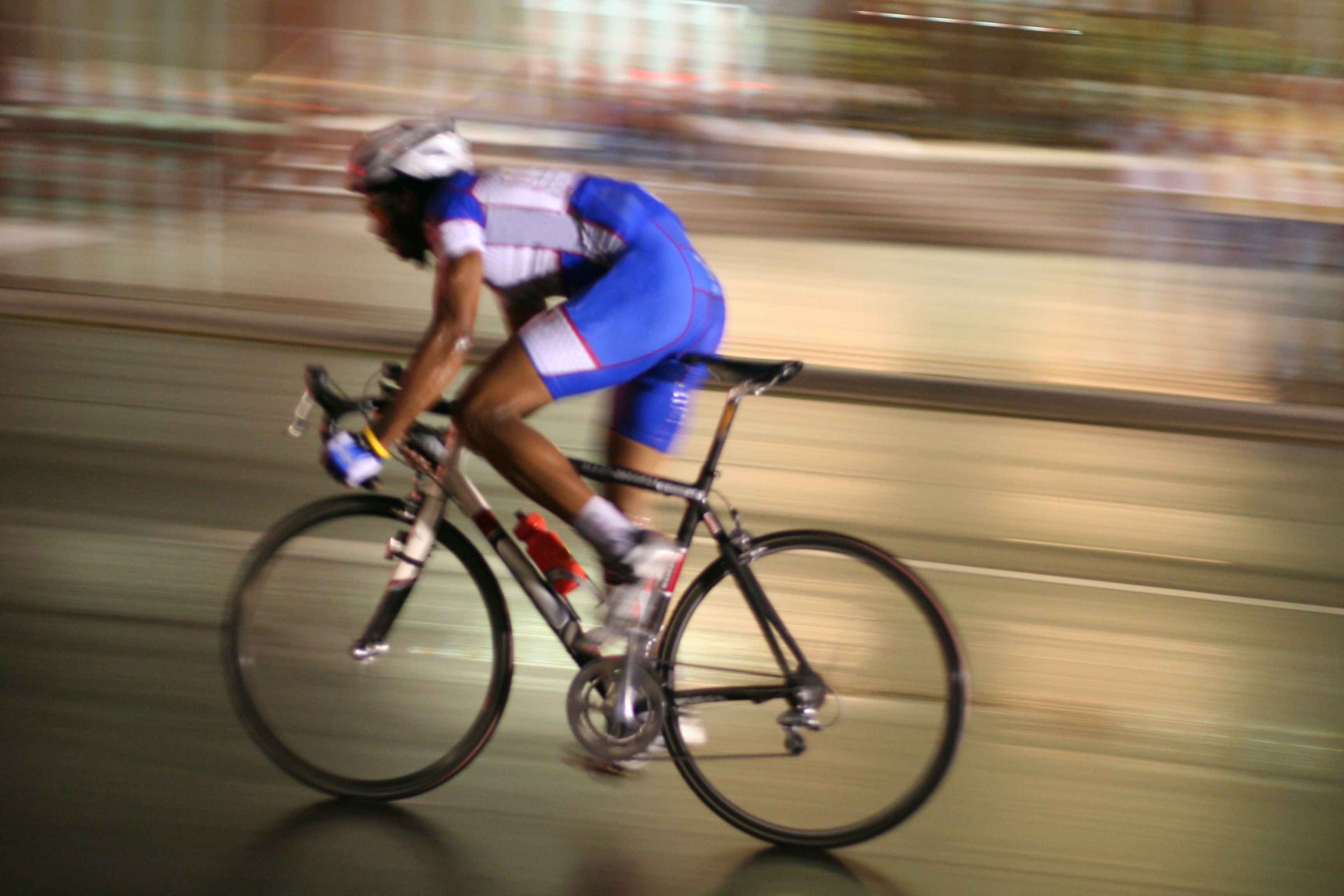 Cyclist zooms by in race held at night