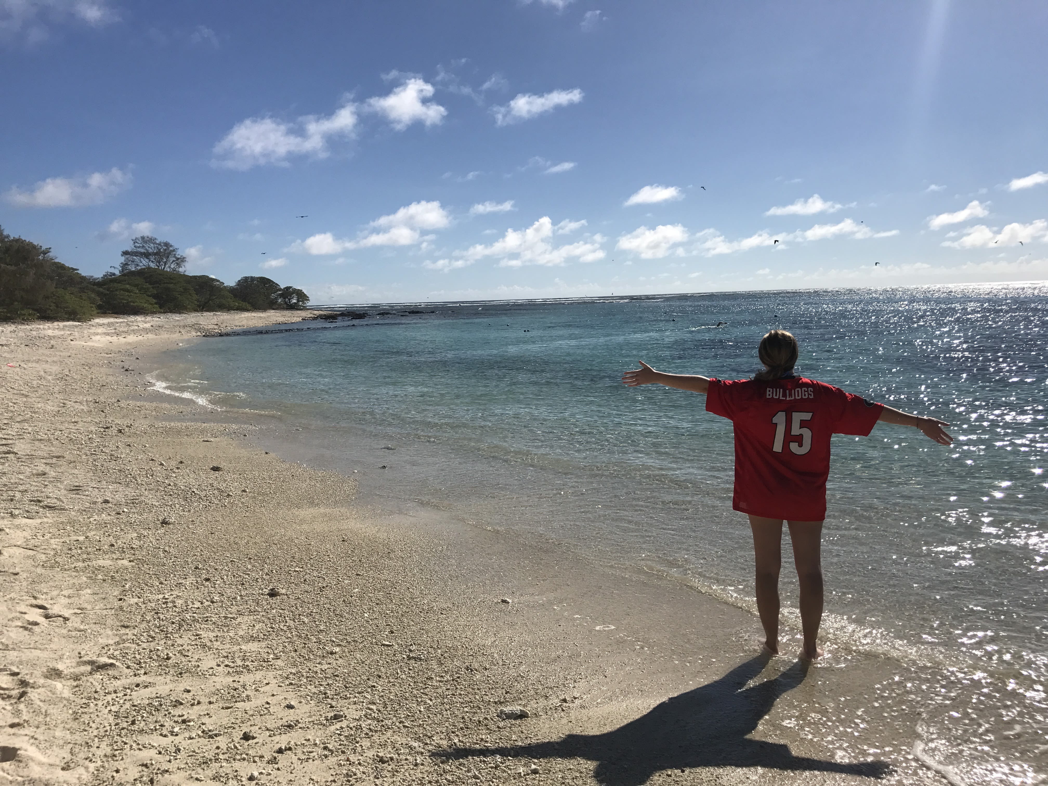 Wearing a Bulldogs jersey, Siragusa stands on the coast during her study abroad trip to Australia