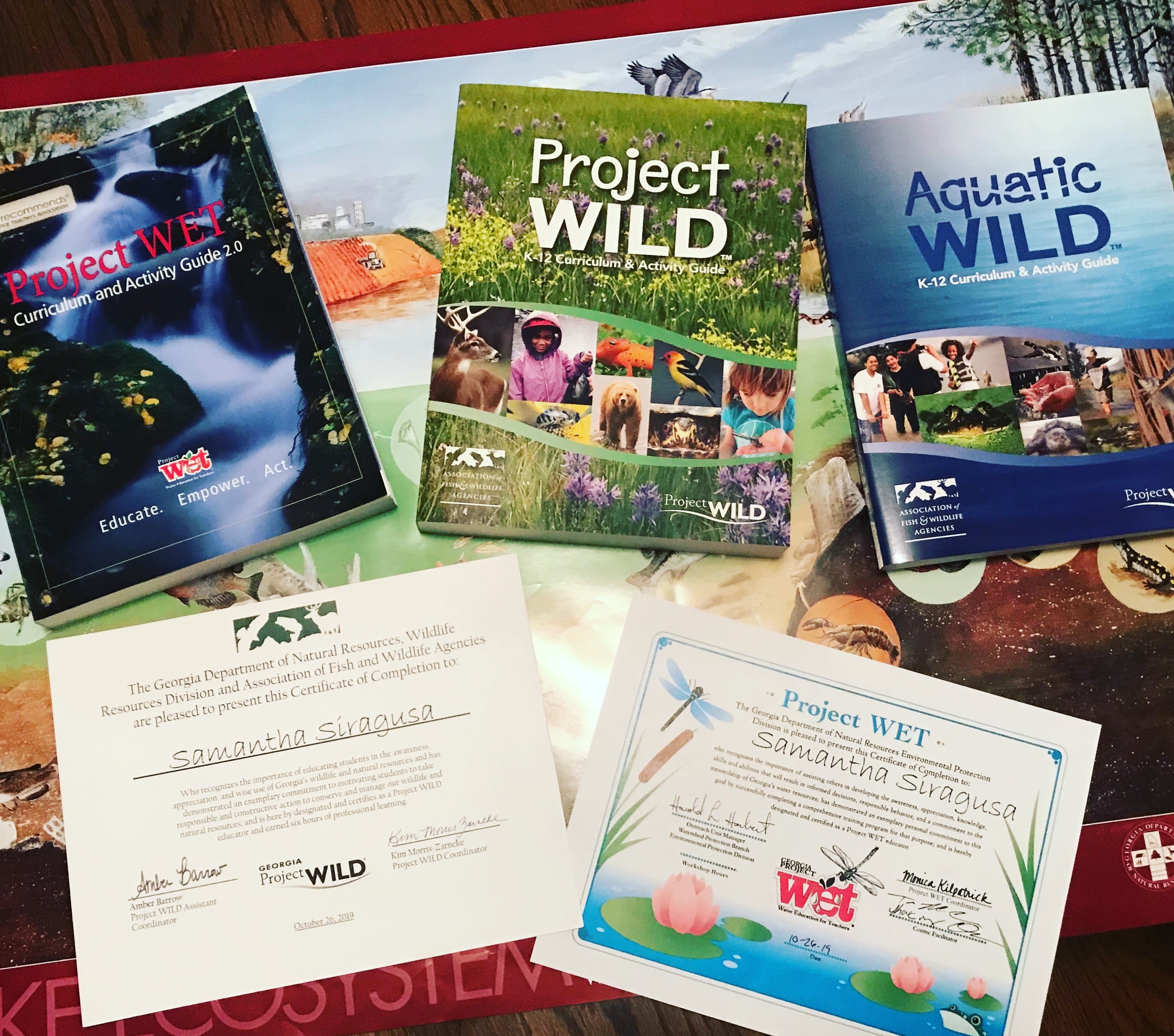 A pile Siragusa's Project WILD and Project WET pamphlets