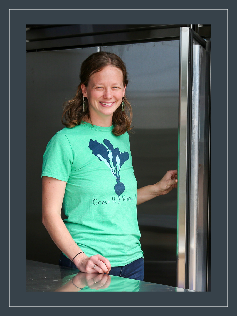 Andie Bisceglia poses for a photo in a commerical kitchen