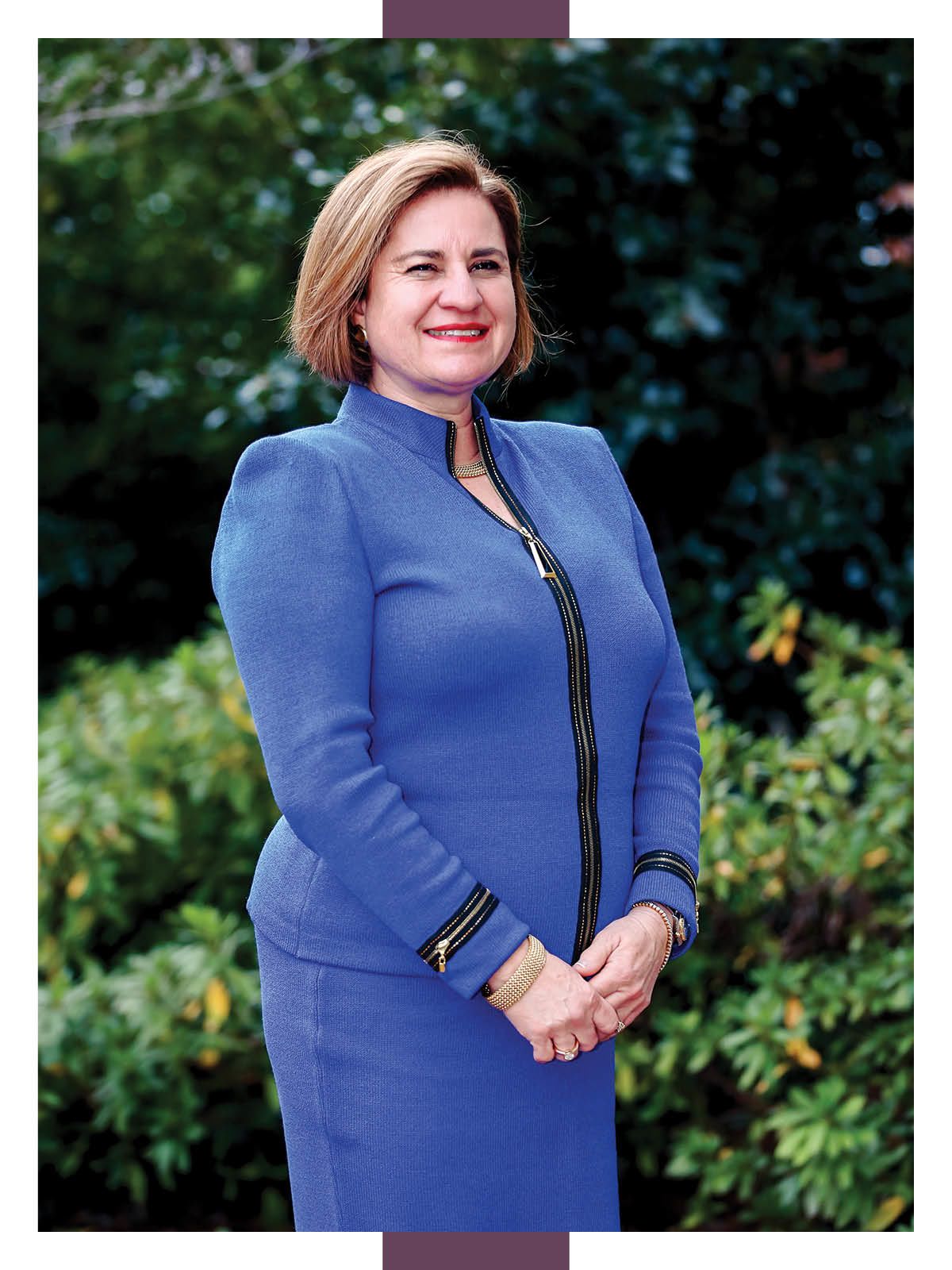Headshot of CEO in a sports jacket and a red tie.
