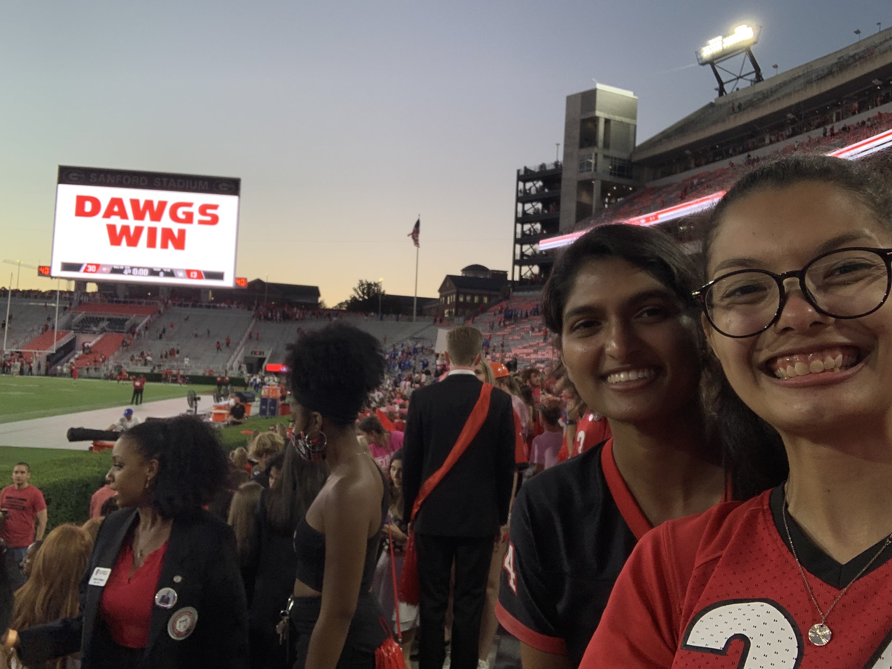 Two students take a selfie at a UGA football game