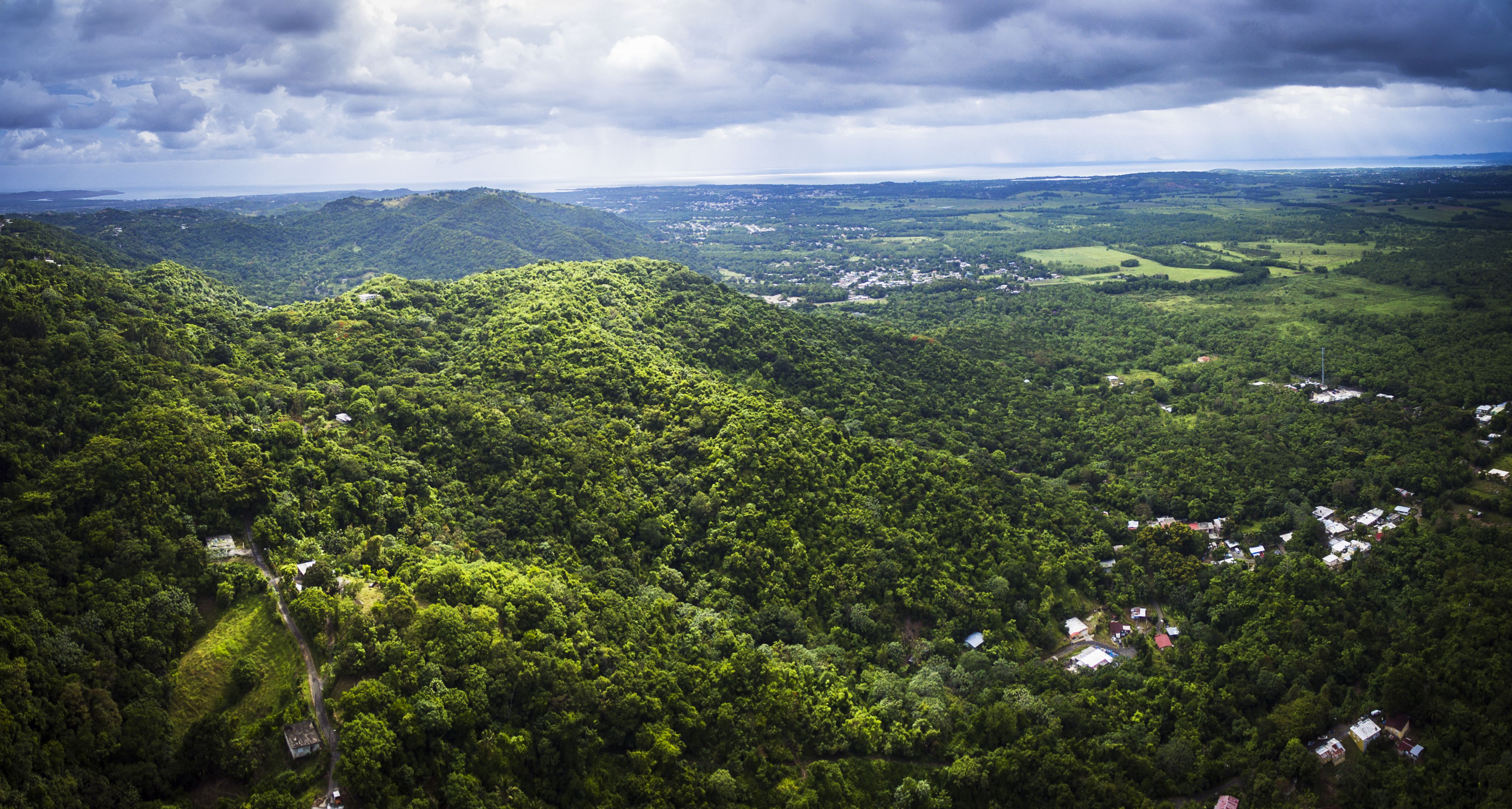Lush, green hills under a cloudy sky