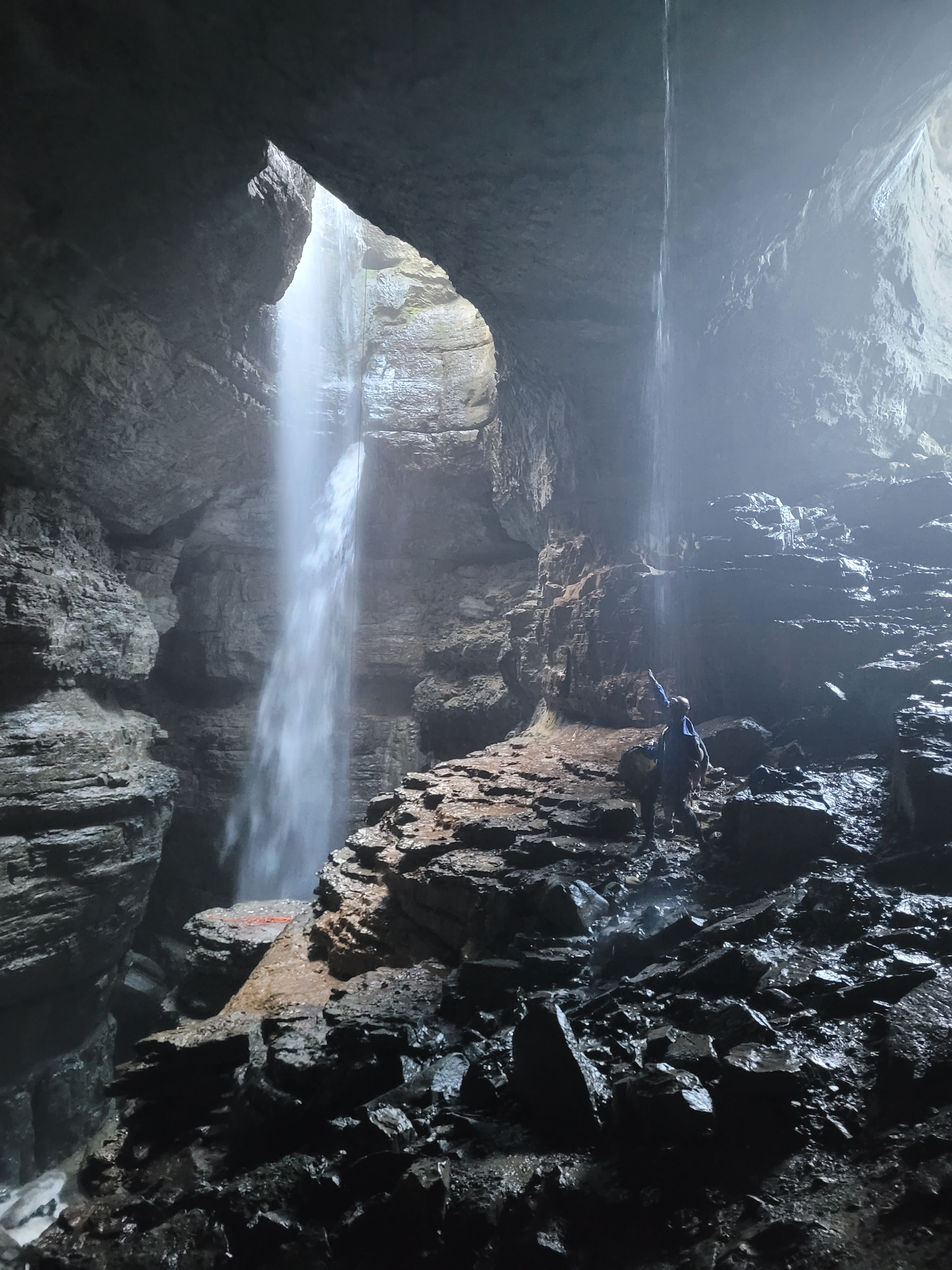 Ashley Lynch poses next to a large underground waterfall