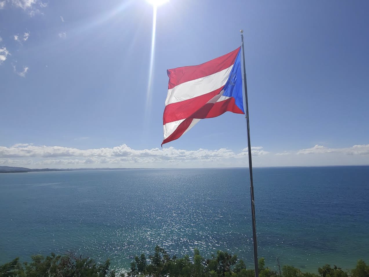 Puerto Rican flag flies high over the Caribbean Sea
