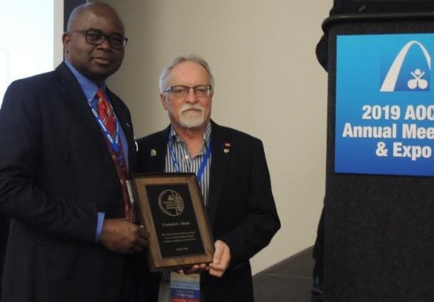Akoh is given an award plaque at an AOCS ceremony in 2019