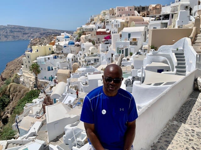 Akoh poses for a photo in the seaside Greek town of Santorini.