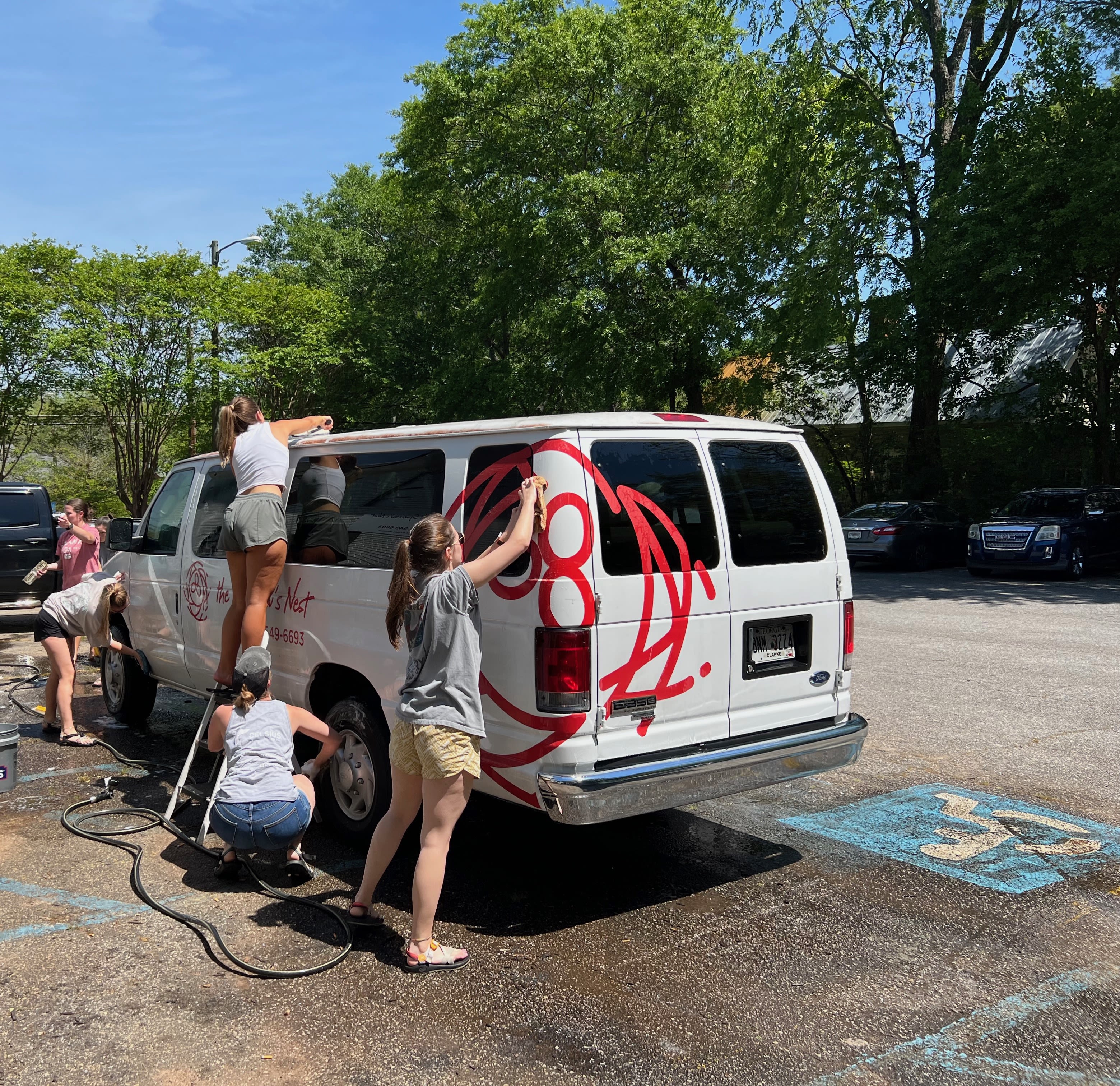 Students wash the Sparrow's Nest van