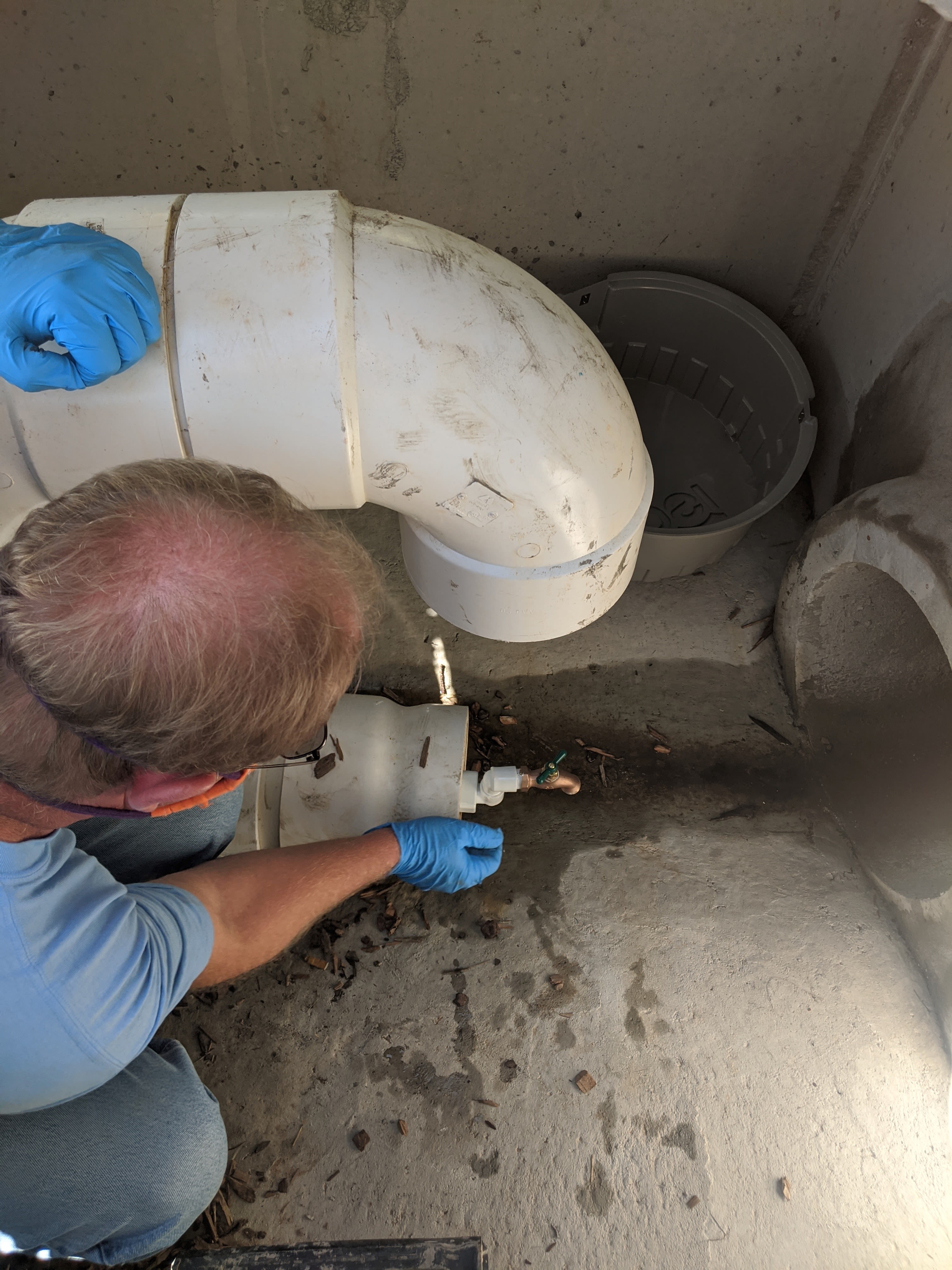 Taken from above, Hawkins wears gloves to work inside of a drop inlet