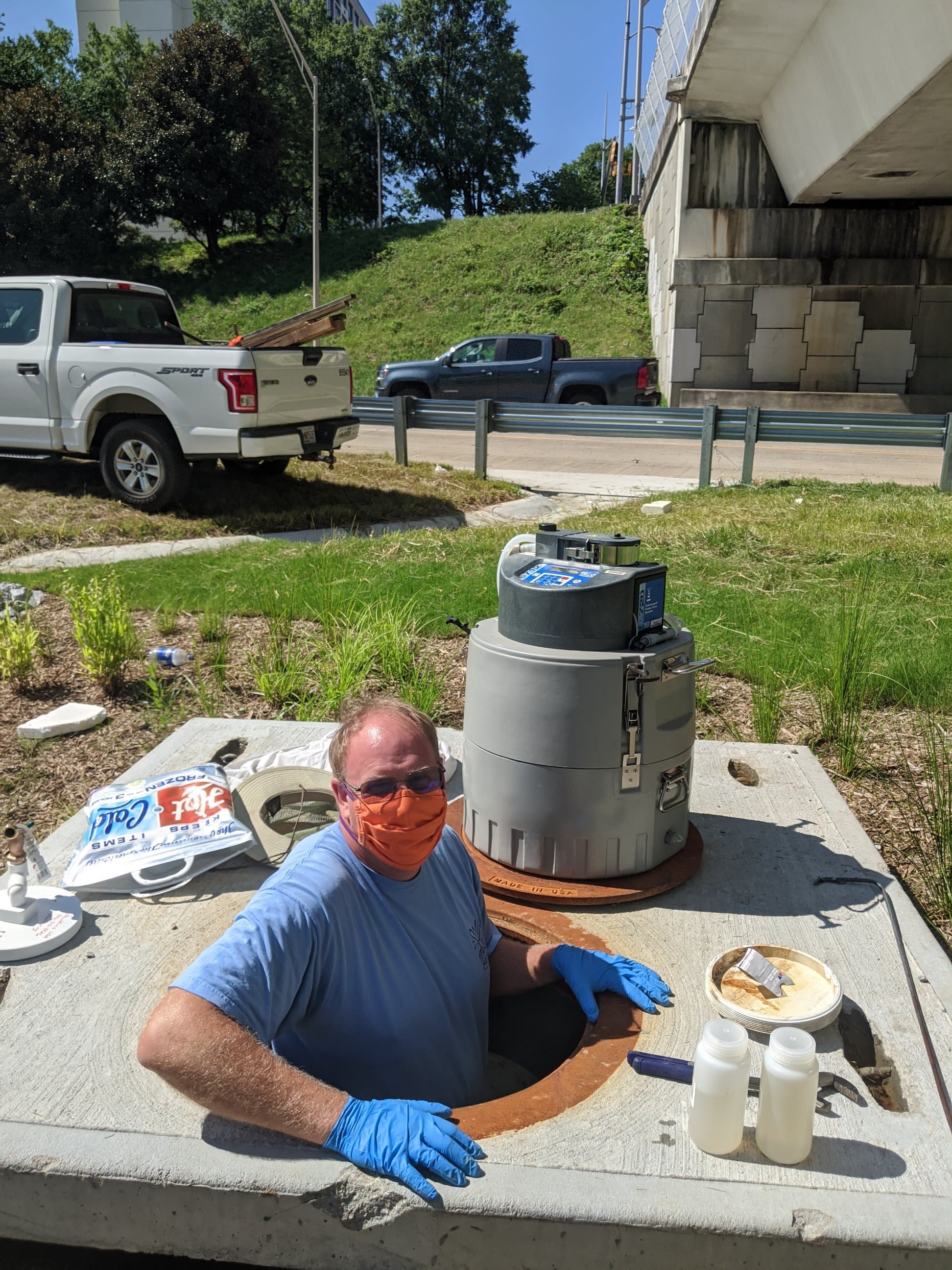 Hawkins climbs down into a drop inlet during the COVID-19 pandemic