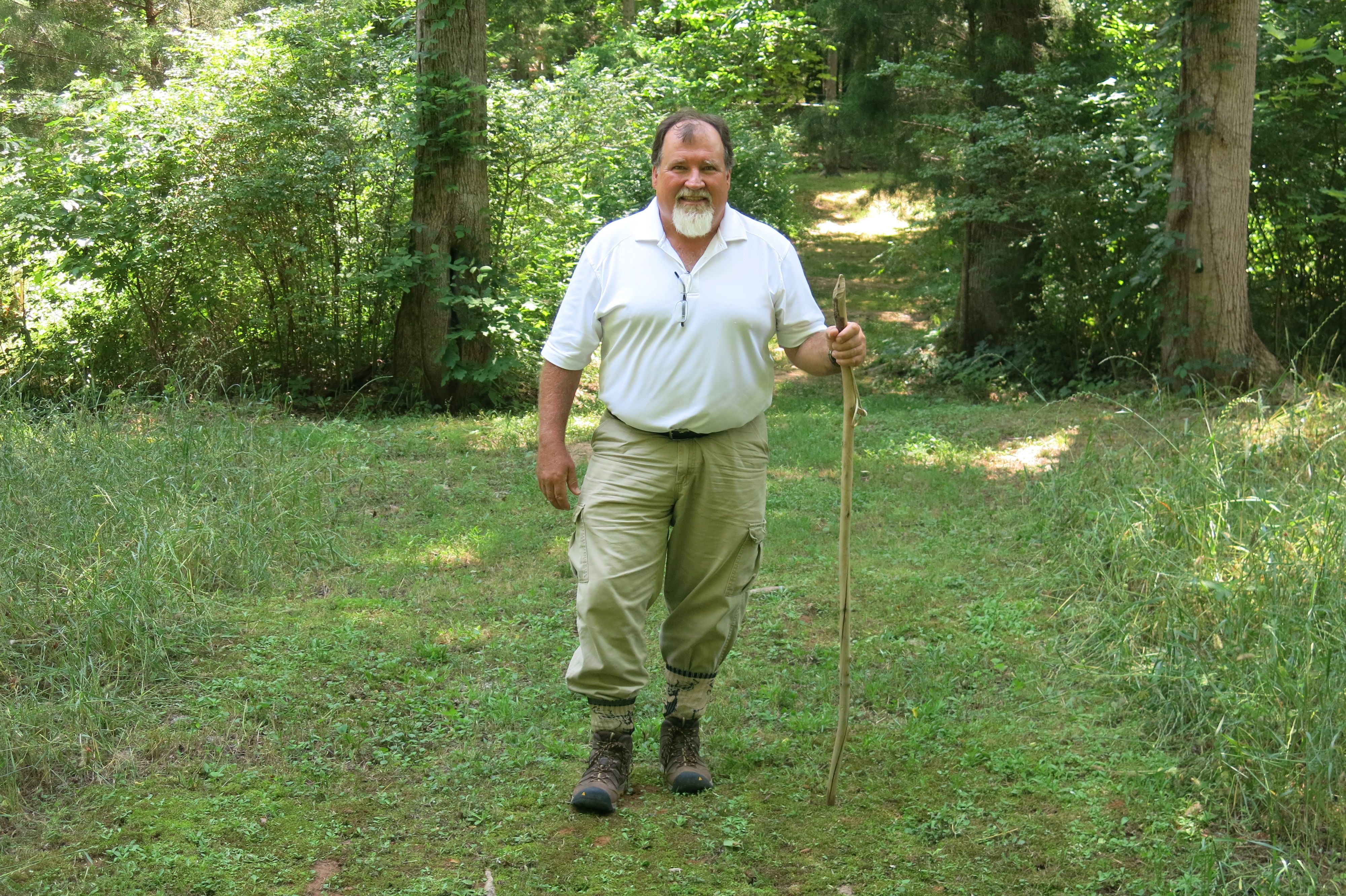 Gray wears pants tucked into his boots to protect himself from ticks while hiking