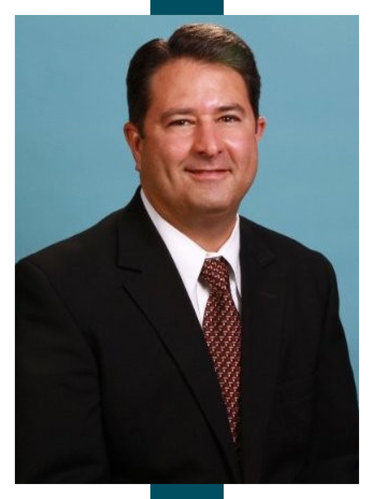 Headshot of Orkin President Freeman Elliott against a blue background