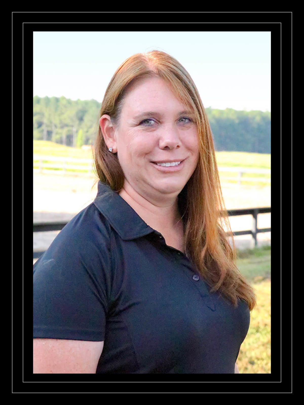 Portrait of woman in front of pasture