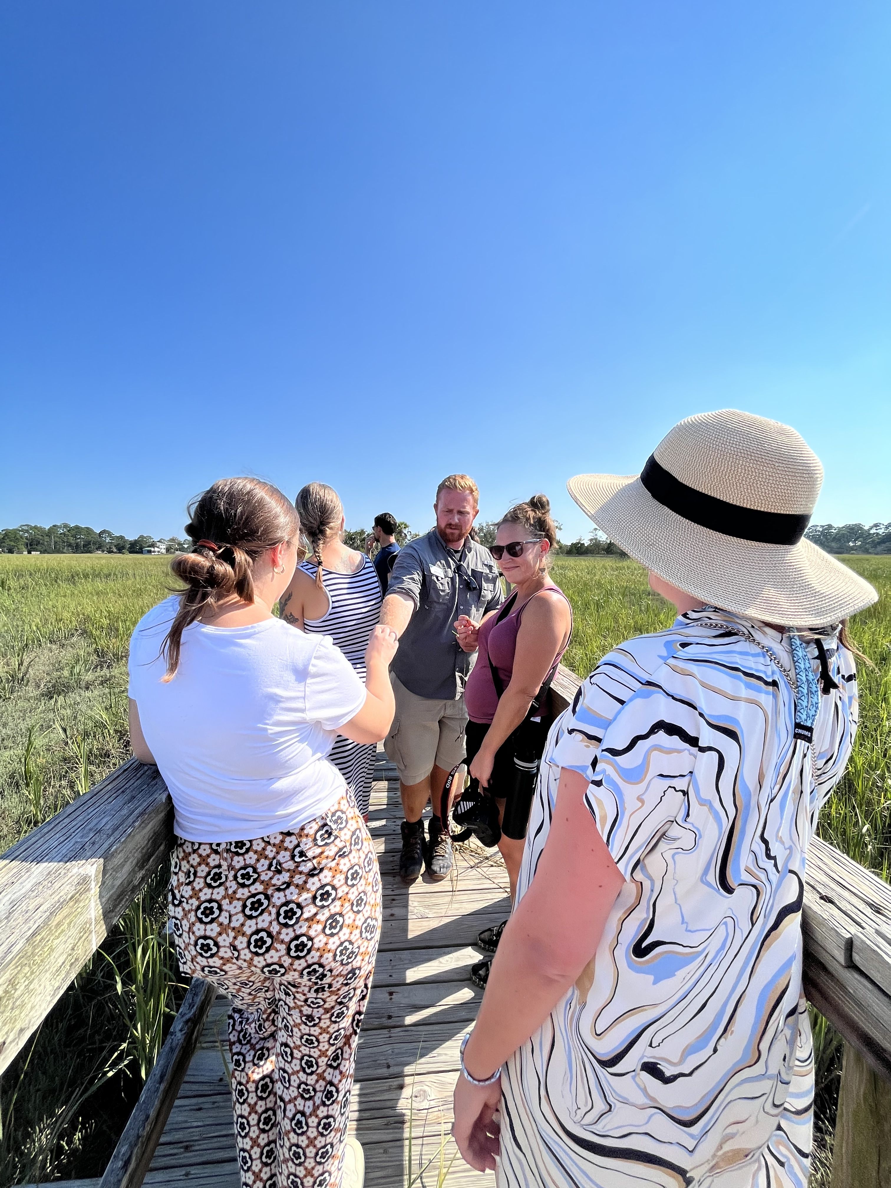 Gorgas stands in the middle of multiple marketing and communications staff, explaining the property and ecosystem