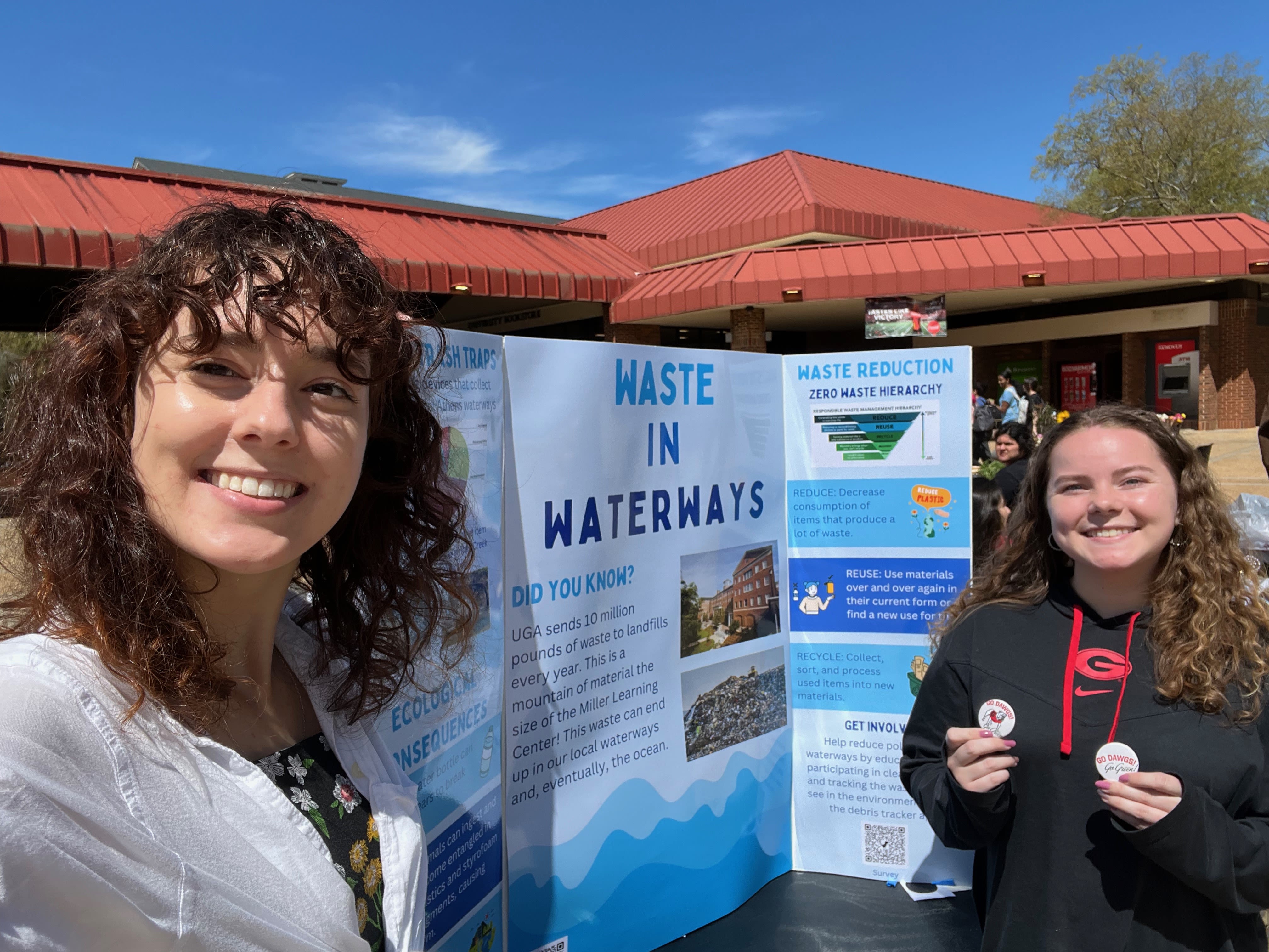 Haley poses with her educational poster board about waste in waterways