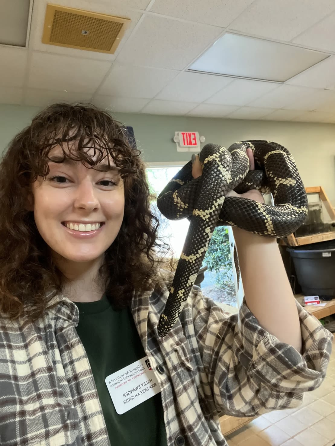 Swanger holds a snake up to the camera at Rock Eagle