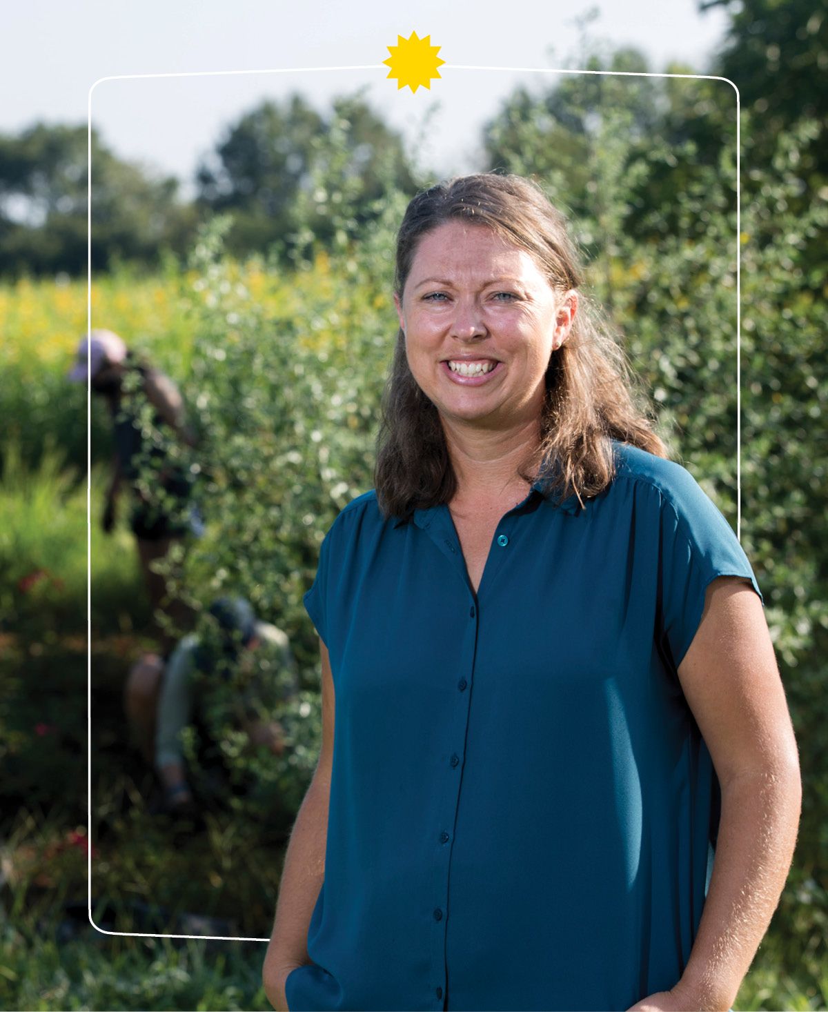 JoHannah Biang standing in front of a field.