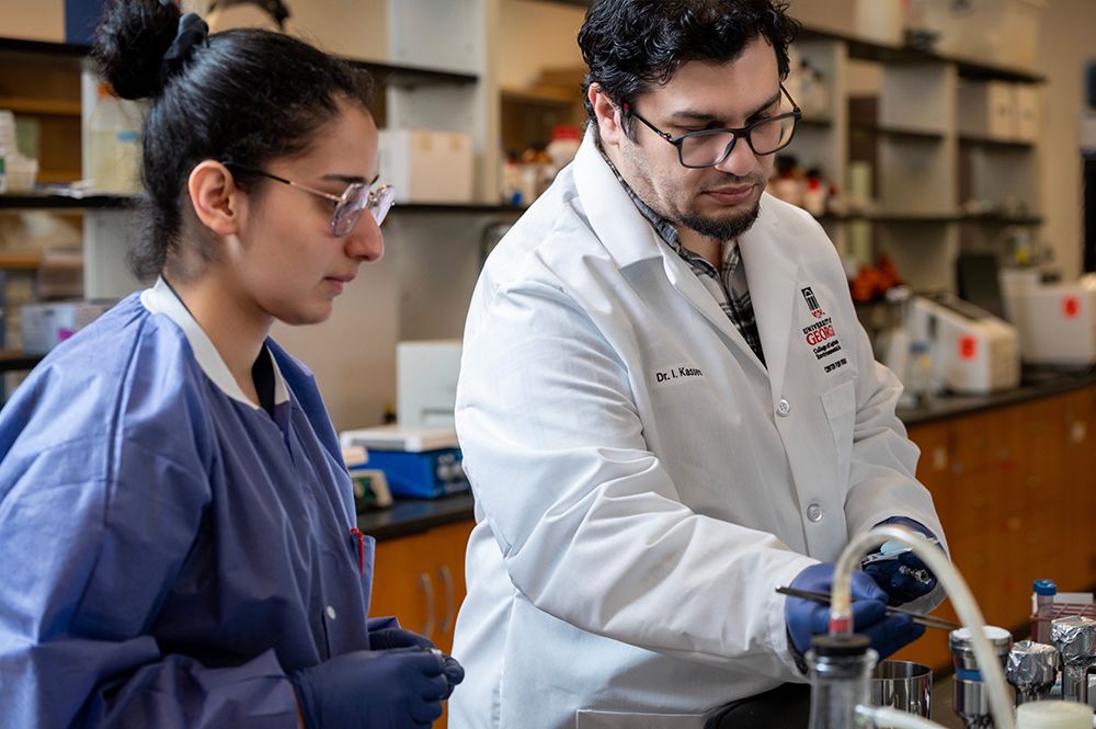 Issmat Kassem with a doctoral student in a lab setting.